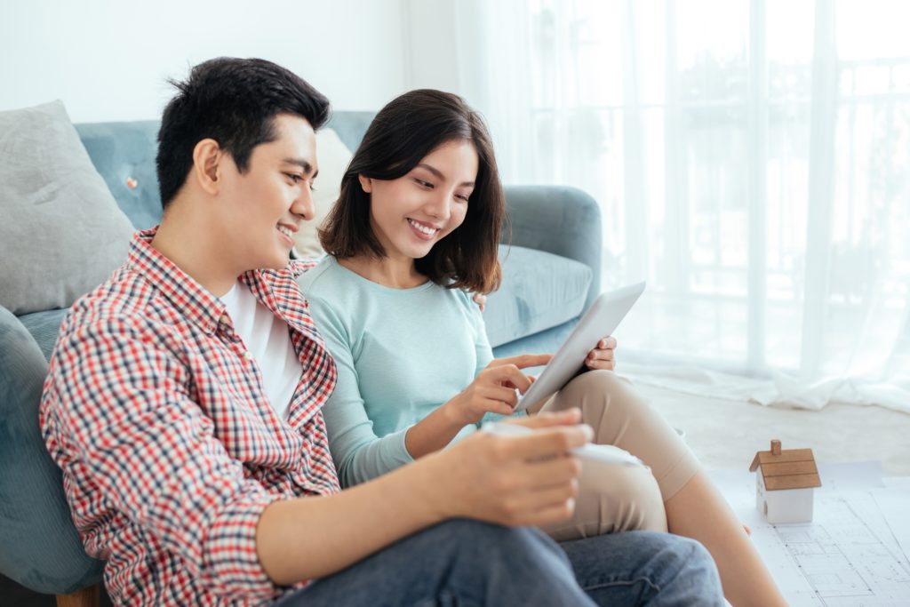 couple sitting on the floor checking the tablet