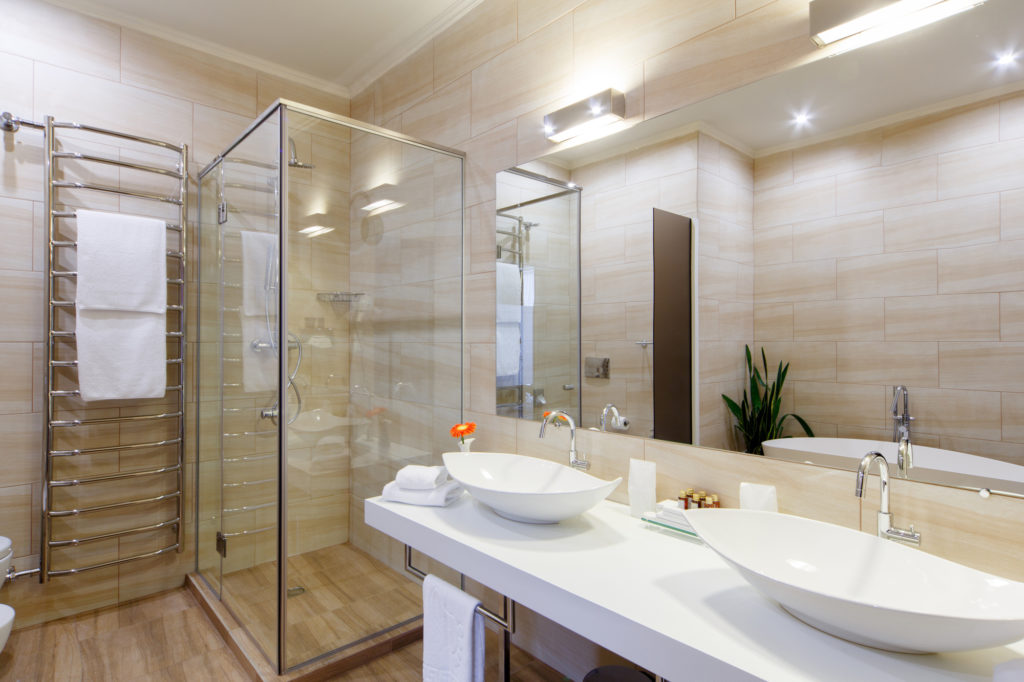 Bathroom of the hotel rooms, with a shower and a few washbasins.